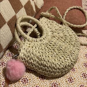 Chic Cream Woven Handbag with Pink Pom Pom